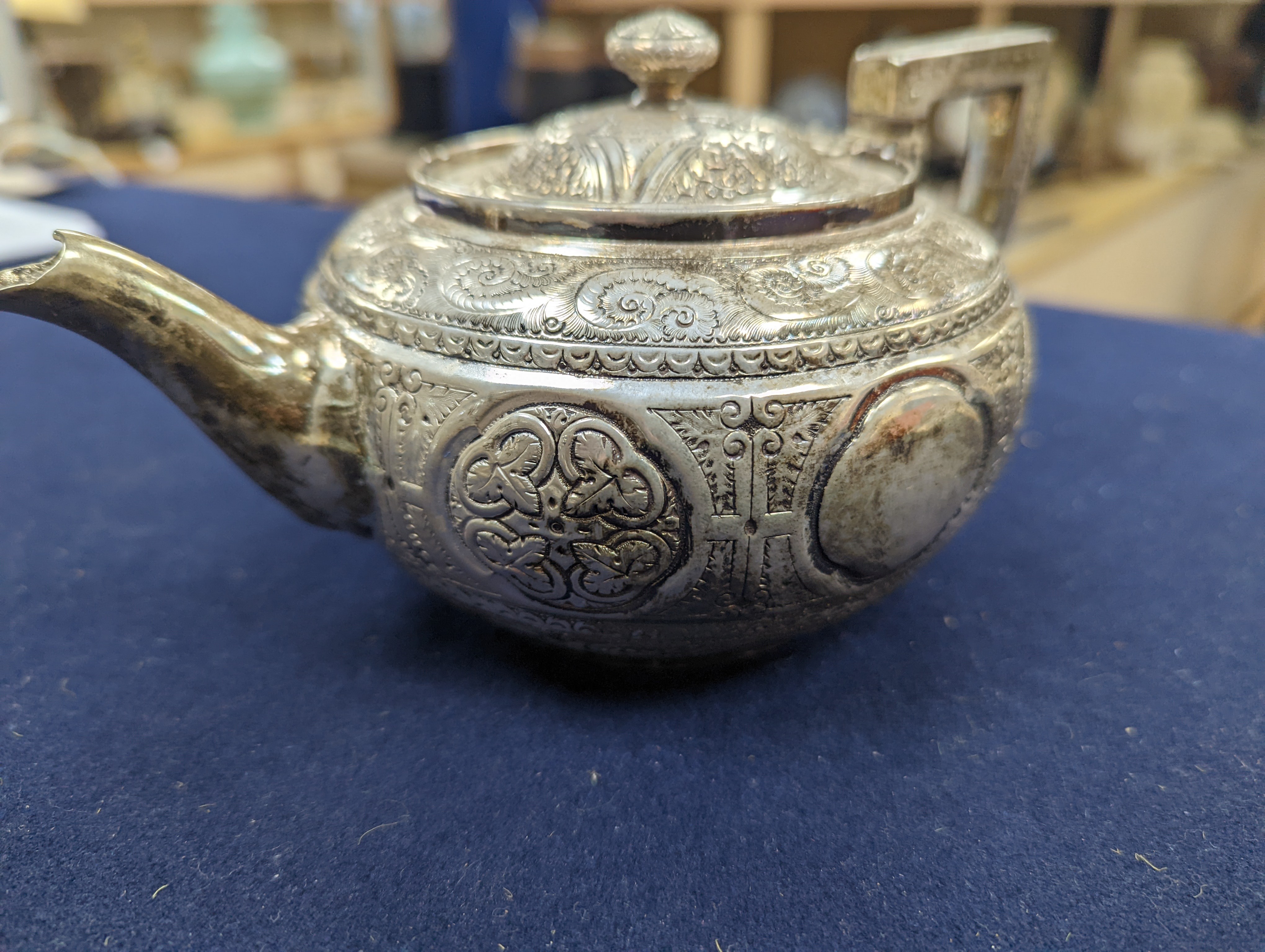 A WMF dish, Islamic white metal mounted photo album and a plated teapot and jug